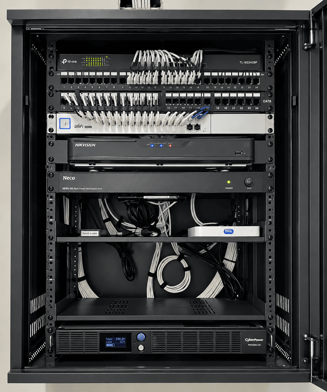 Organized network rack with TP-Link switches, patch panels, Hikvision NVR, and a CyberPower UPS.